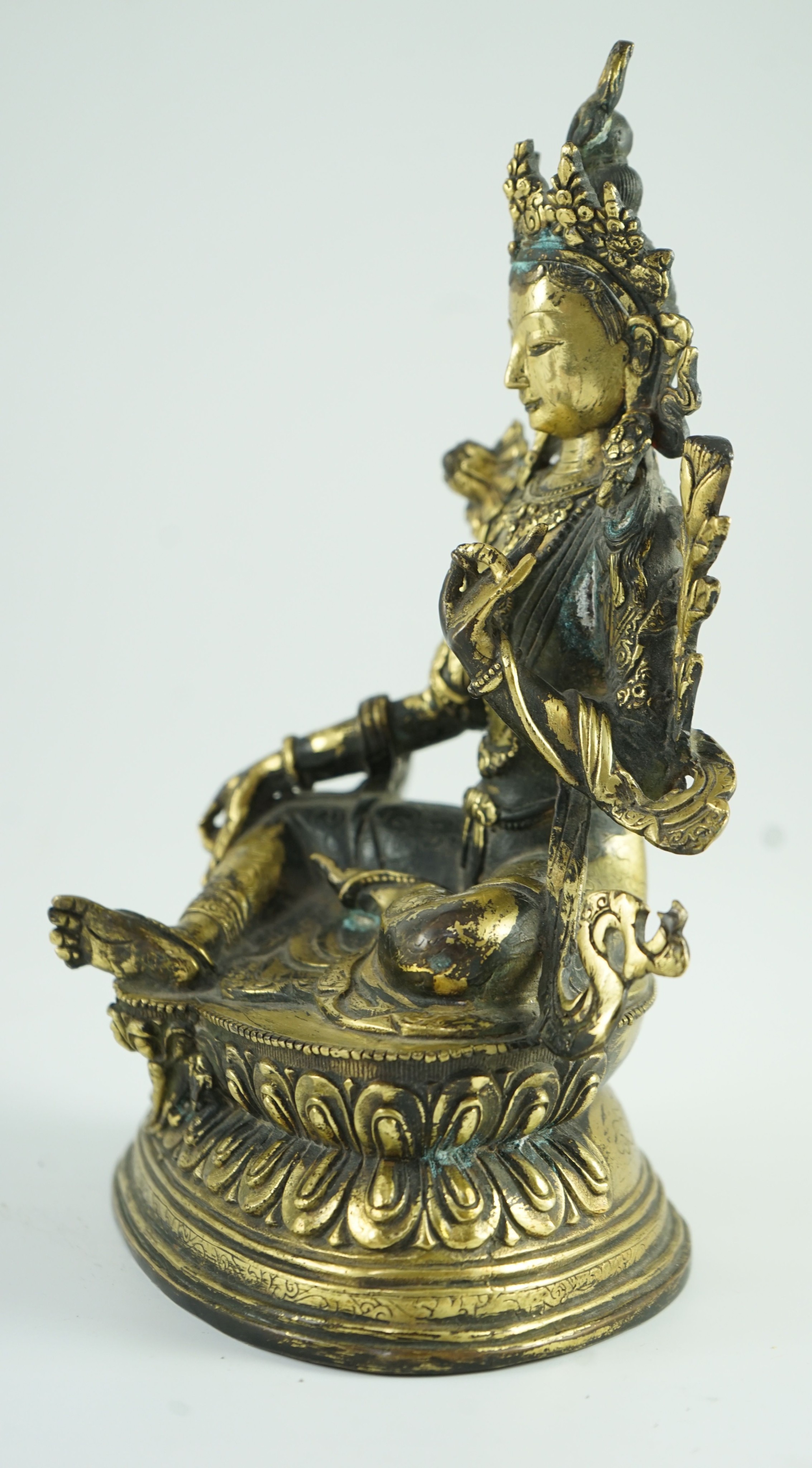 A Sino-Tibetan bronze seated figure of Green Tara, 23.5 cm high